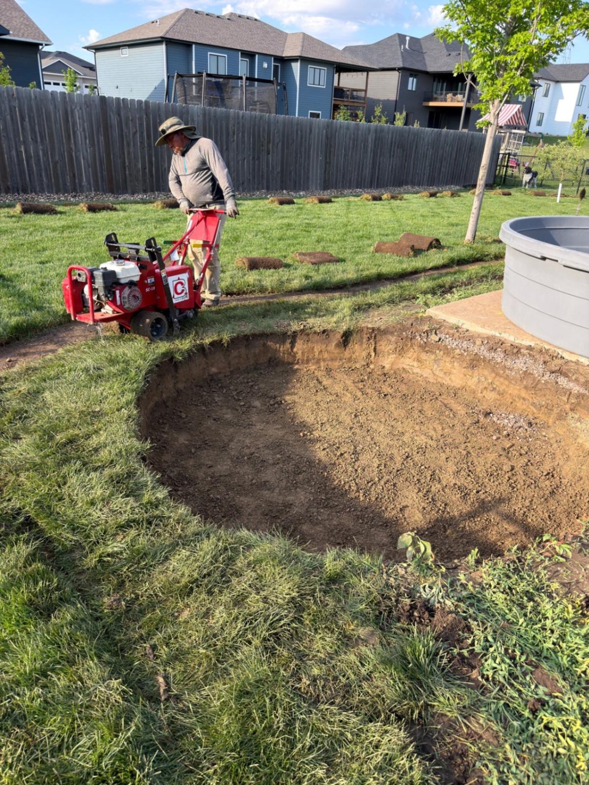 During — excavation of the curved seat wall footprint with the sod cutter working the perimeter