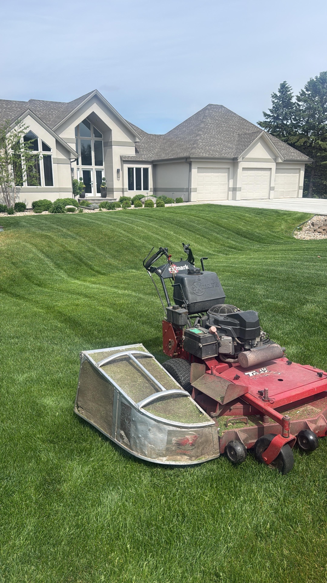 Freshly mowed front lawn with crisp stripes in front of a large stucco home