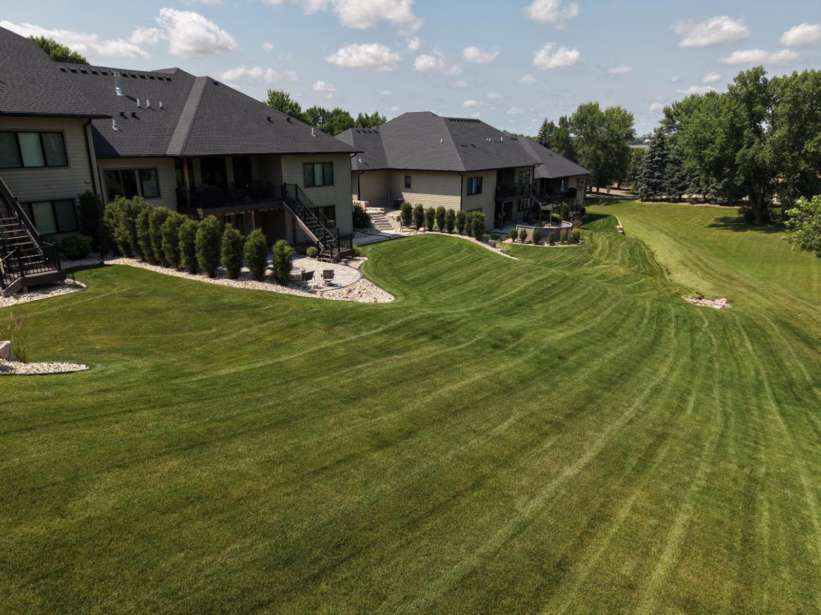 Aerial view of a Sioux Falls backyard with crisp curved mowing stripes