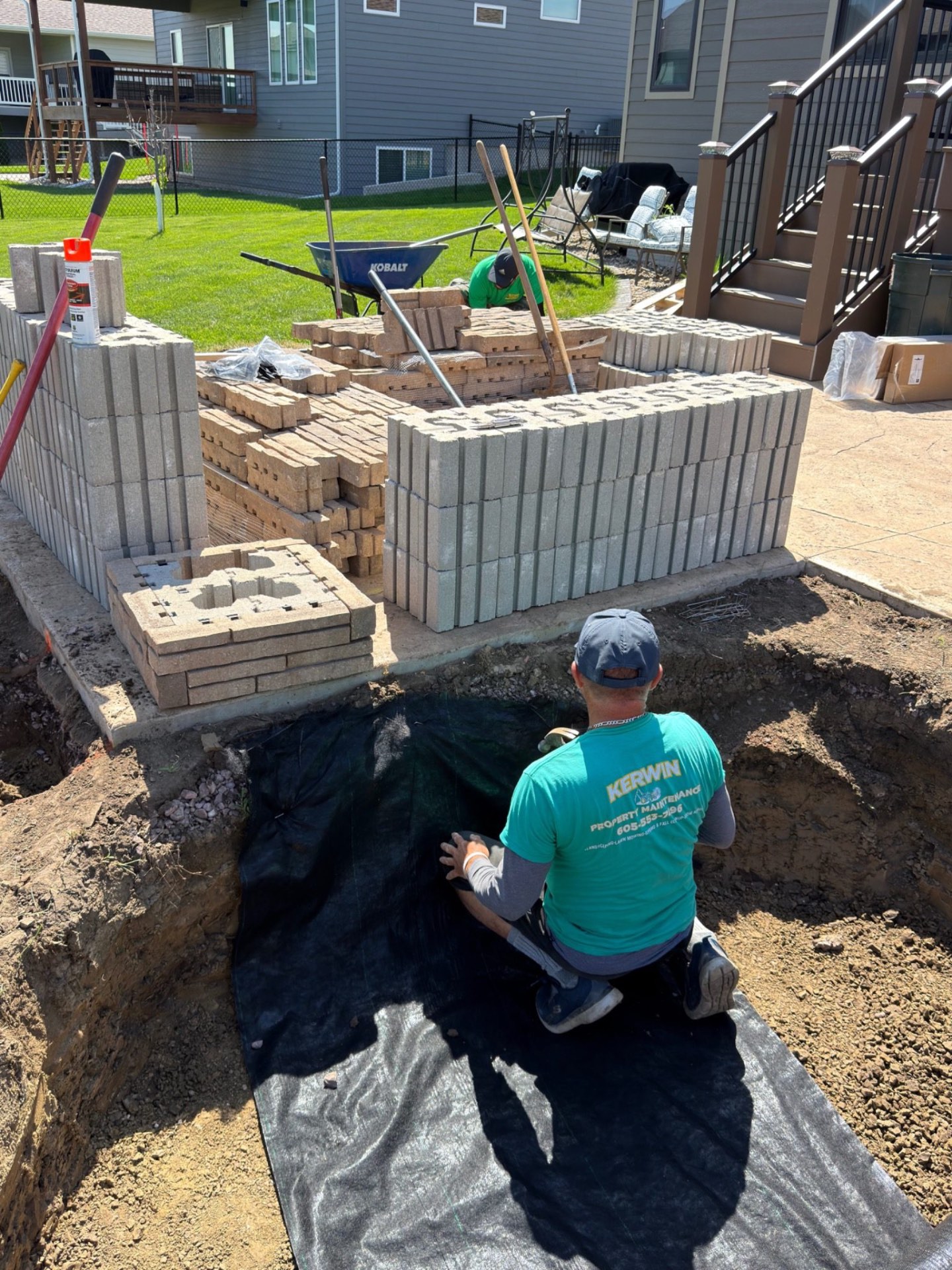 During — stacking the retaining wall blocks and setting the base for the custom curved seat wall build