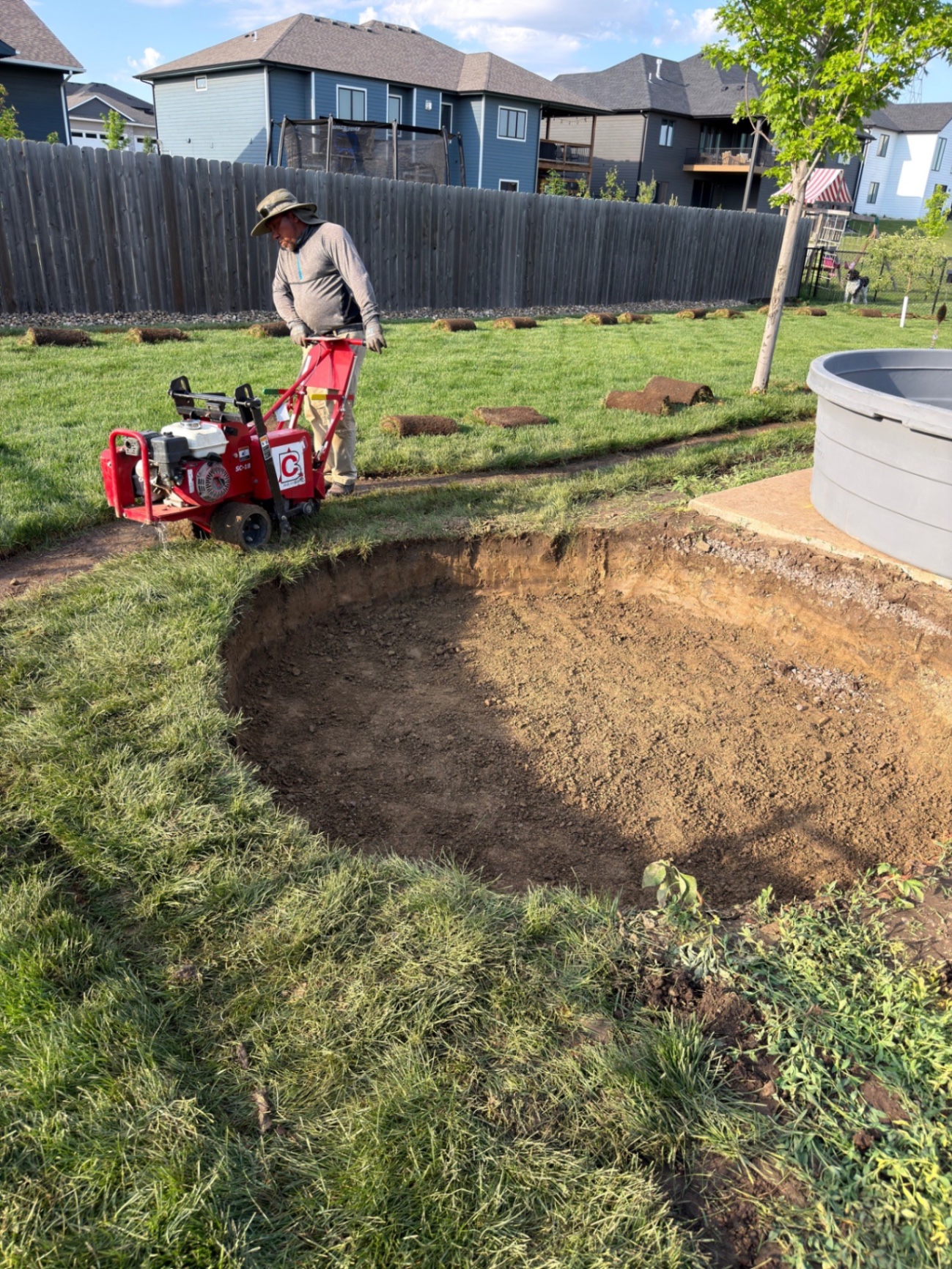 During — excavation of the curved seat wall footprint with the sod cutter working the perimeter