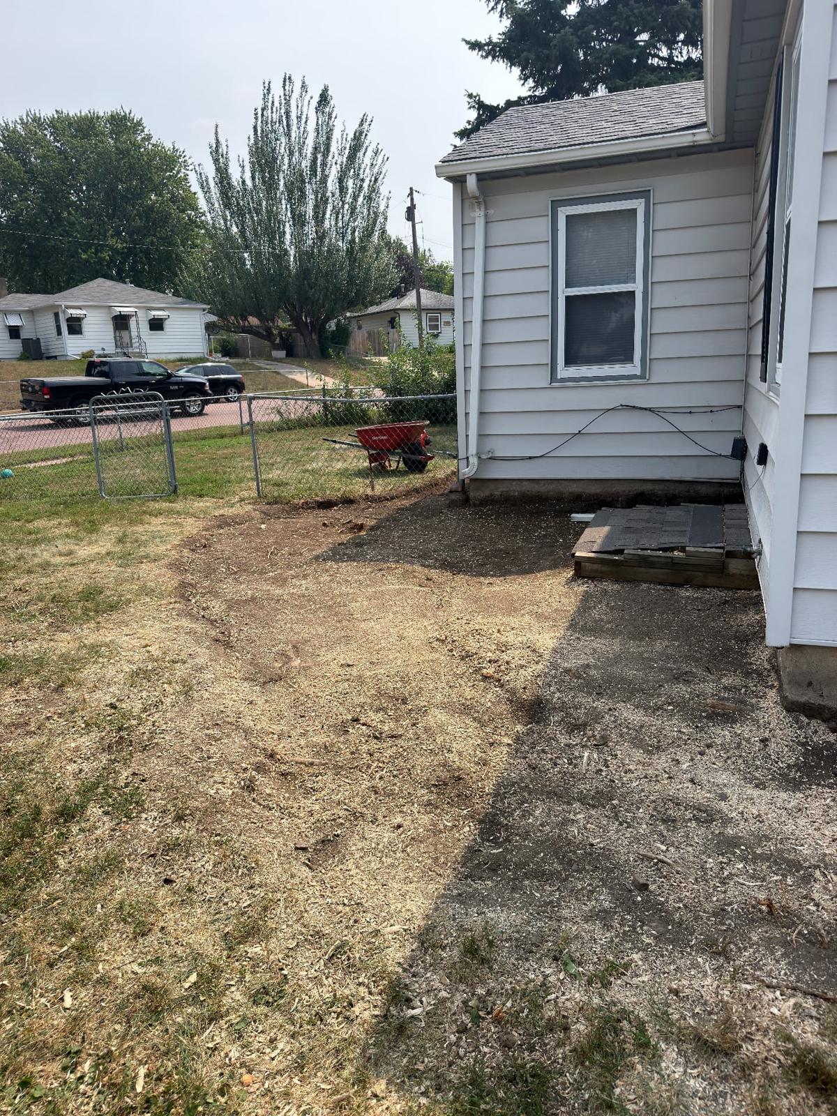 During — beds stripped out and regraded along the back of the house so water sheds away from the foundation