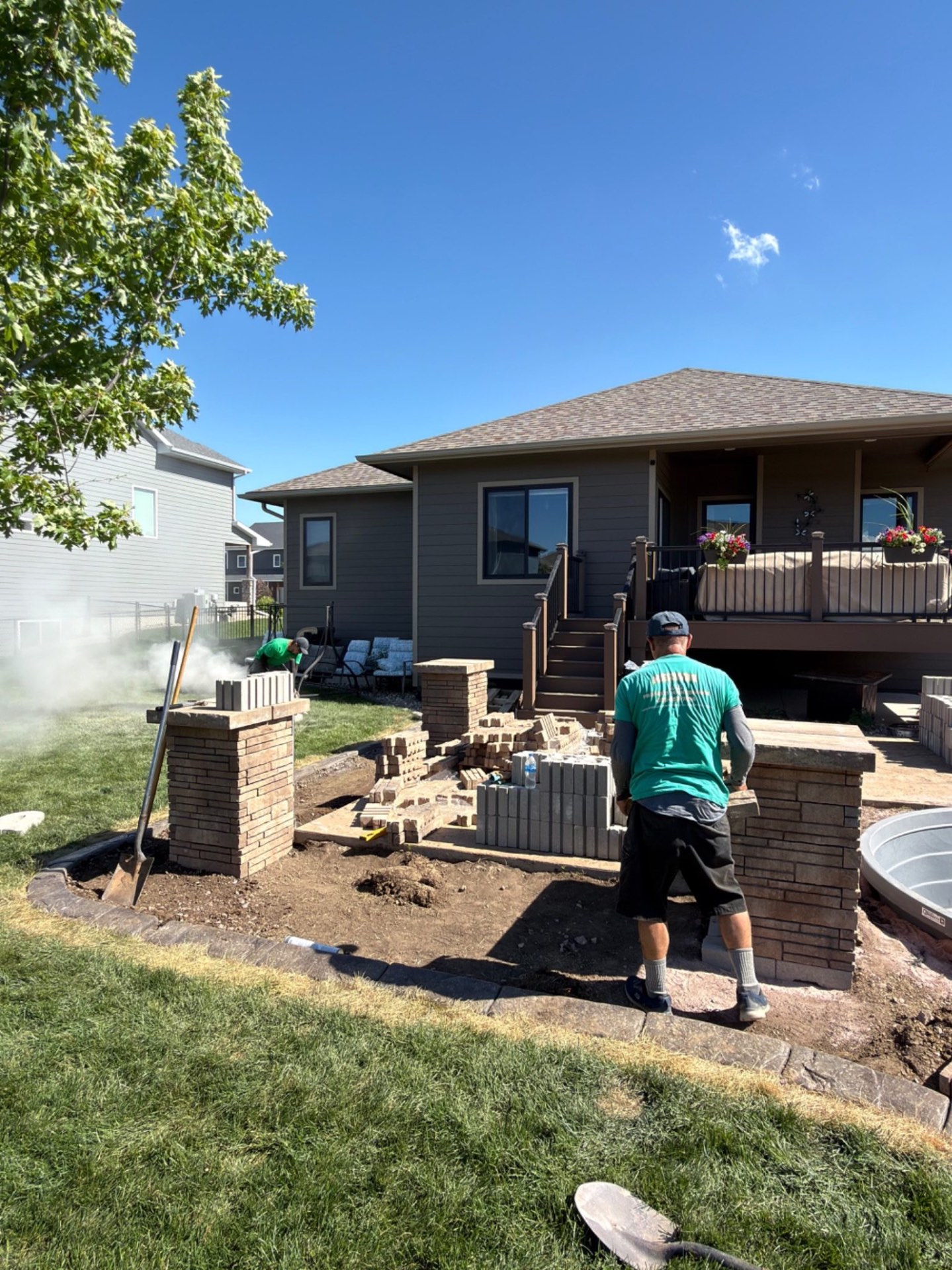 During — brick columns going up as the seat wall structure takes shape around the new patio area