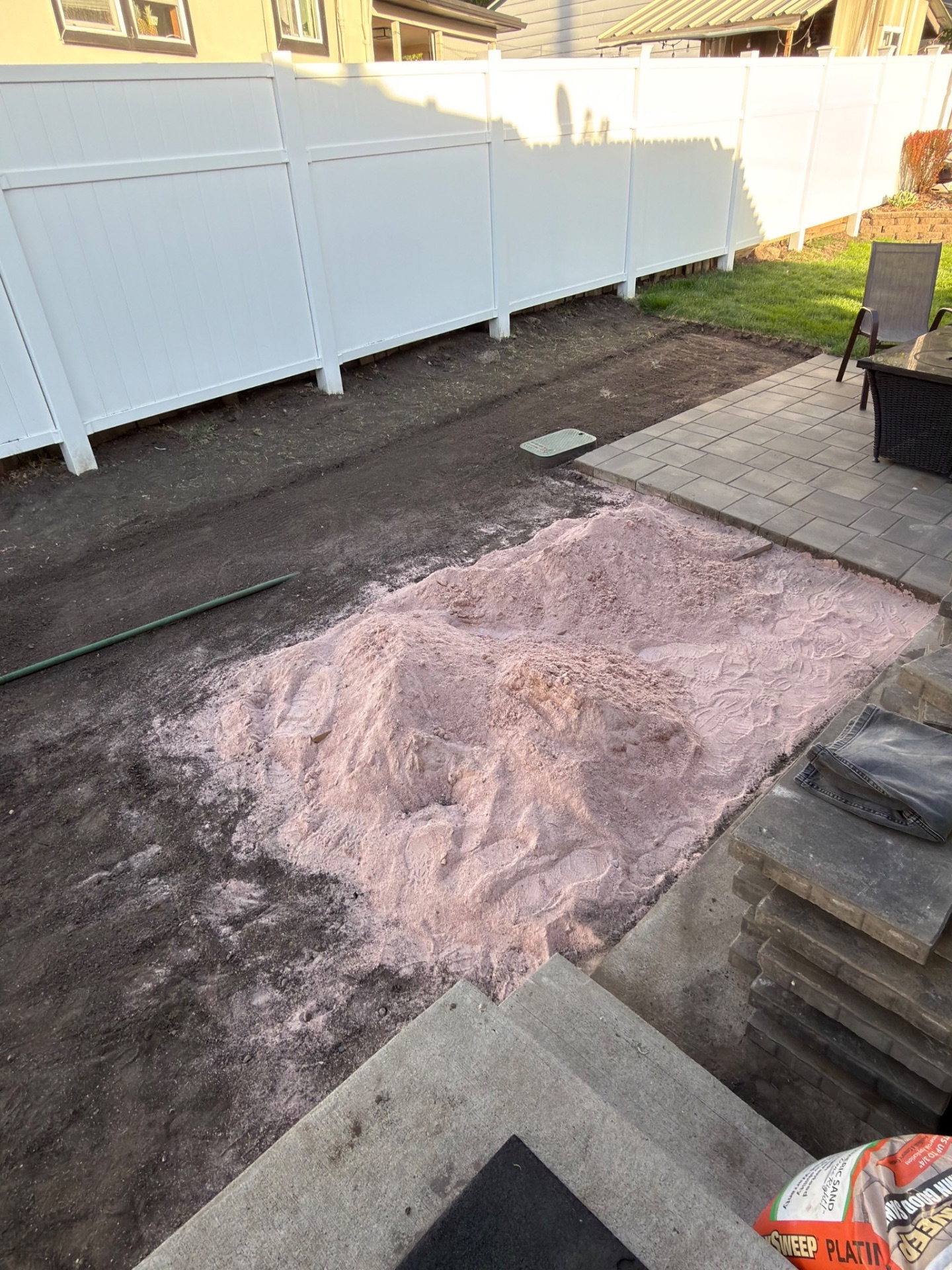 Sand base prepped next to existing pavers before install